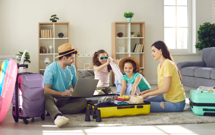 Happy,Young,Family,Packing,Bags,For,Vacation,Trip.,Parents,And